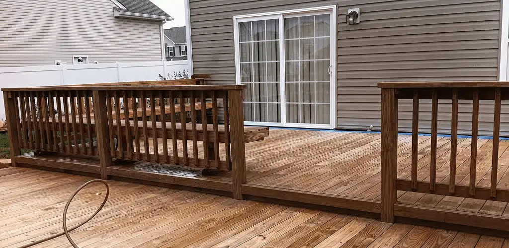 Deck sealing service protecting a backyard wood deck and railings in Jersey City, NJ