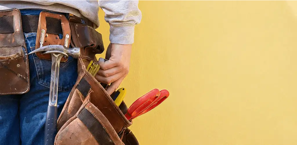 Handyman with tool belt ready for home repairs and maintenance in Jersey City, NJ
