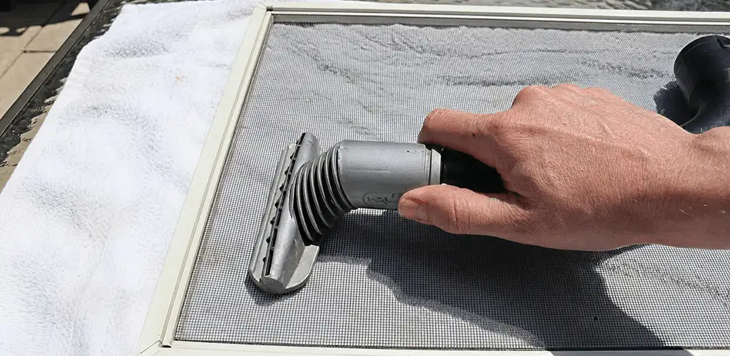 Window screen repair cleaning and fixing a damaged screen mesh in Jersey City, NJ